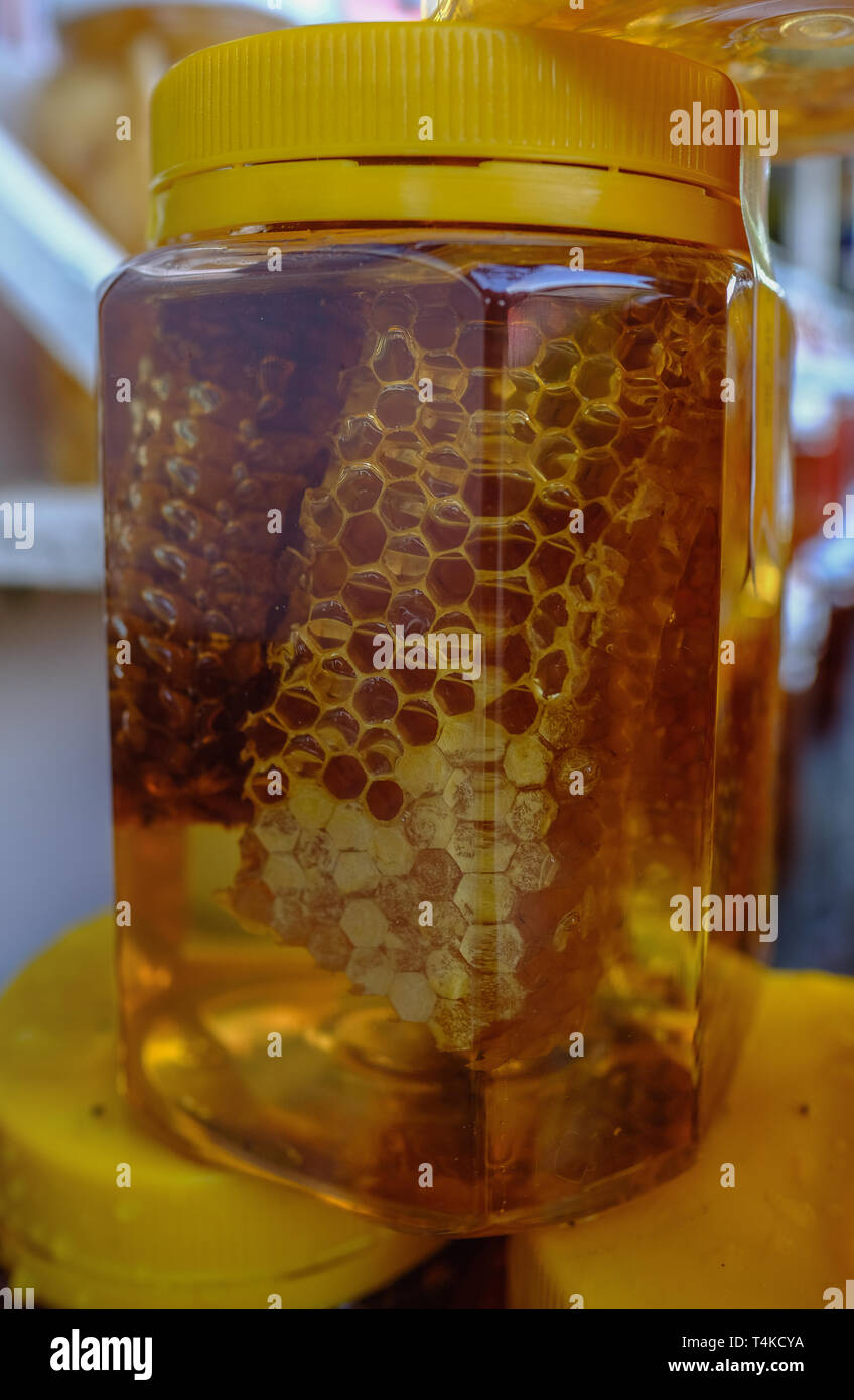 Closeup view of golden honey with in a plastic jar Stock