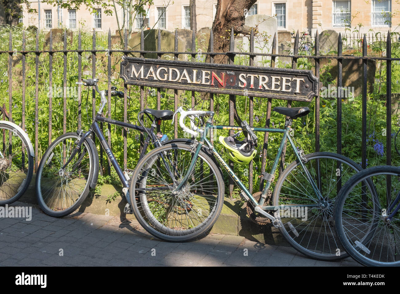 Bicycles attached to railings in Magdalen Street, Oxford, UK Stock Photo