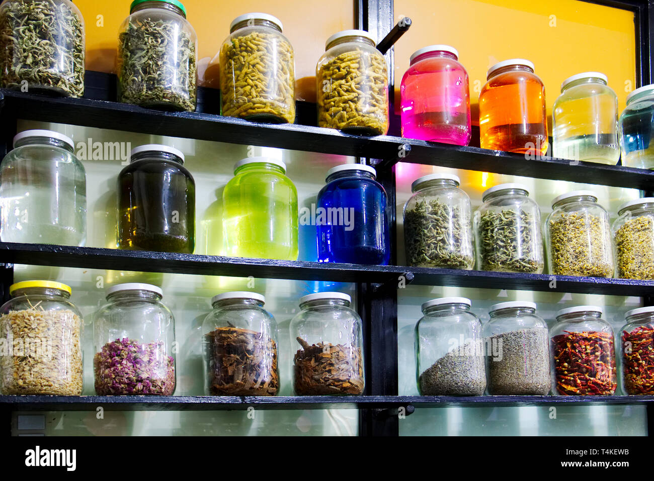 Shelves of colorful jars containing herbs spices and traditional medicines at an apothecary in the souk at Marrakesh Morocco Stock Photo Alamy