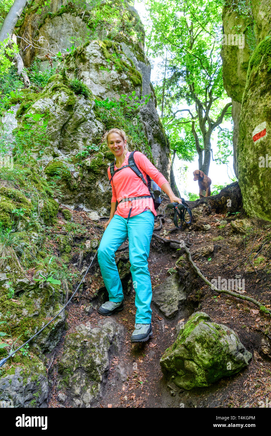 Young woman on challenging root trail in forest Stock Photo