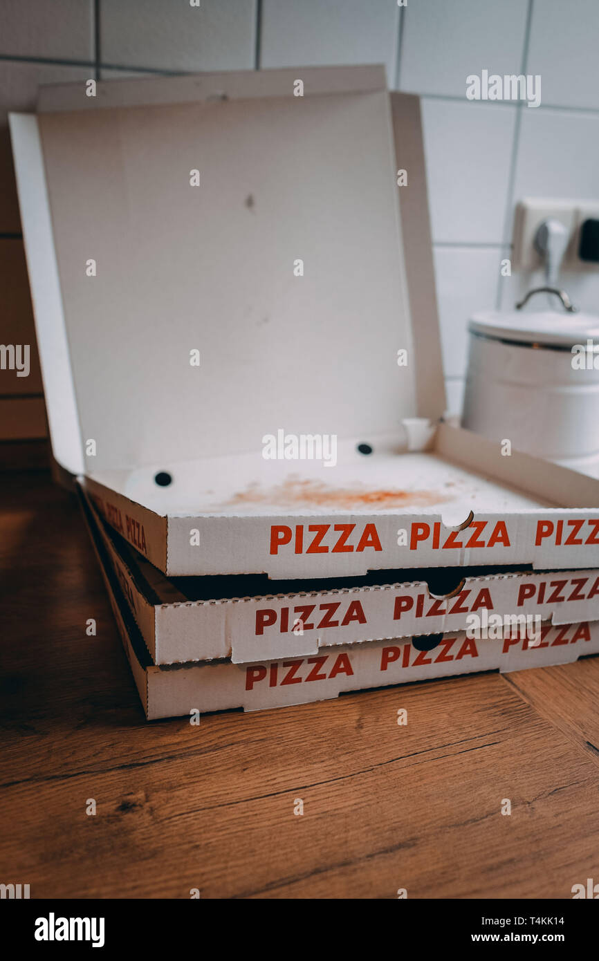 Empty pizza boxes in a kitchen the day after a party Stock Photo Alamy