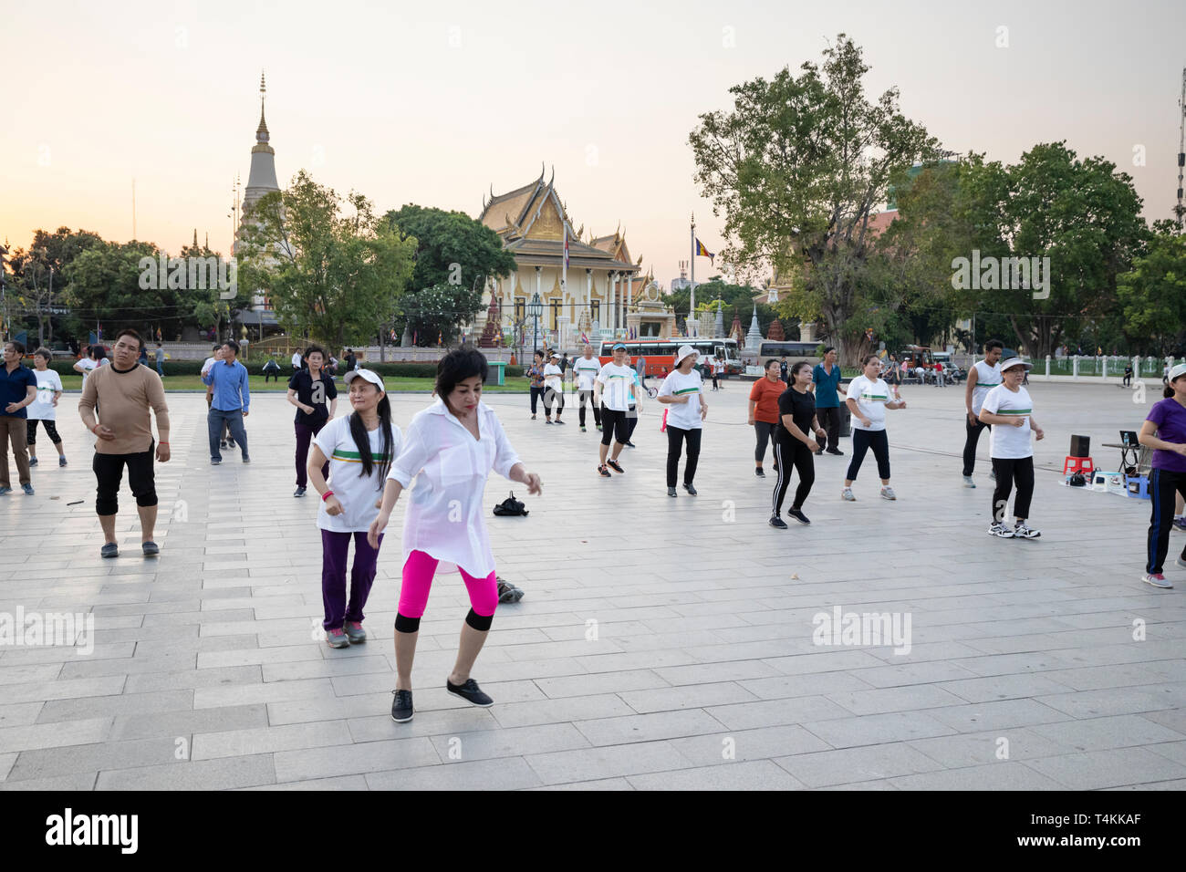 Locals doing aerobics at sunset in the Wat Botum Park, Phnom Penh, Cambodia, Southeast Asia, Asia Stock Photo