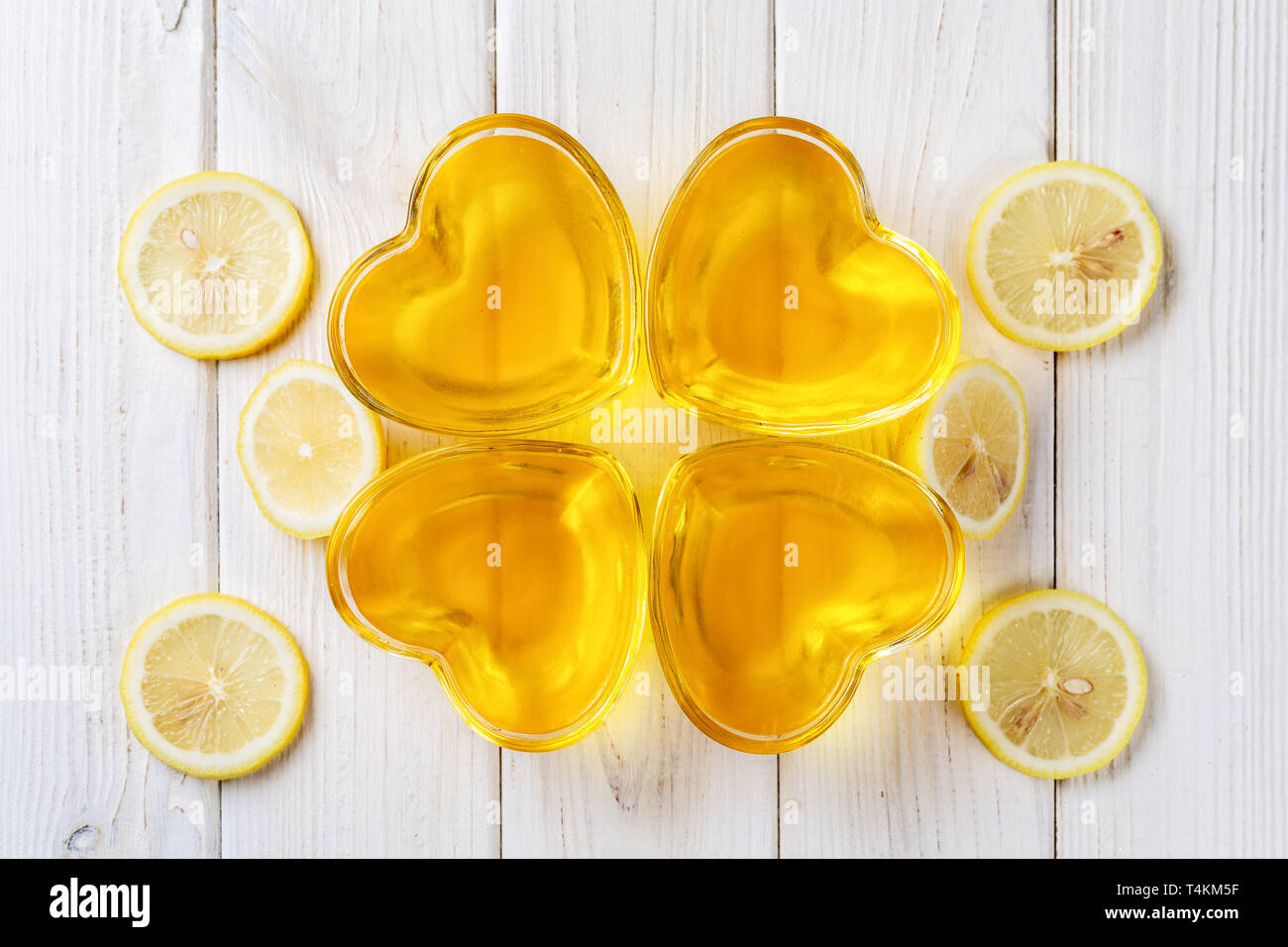 Yellow lemon jelly jello in heart shaped glass on white wooden background,  top view Stock Photo - Alamy