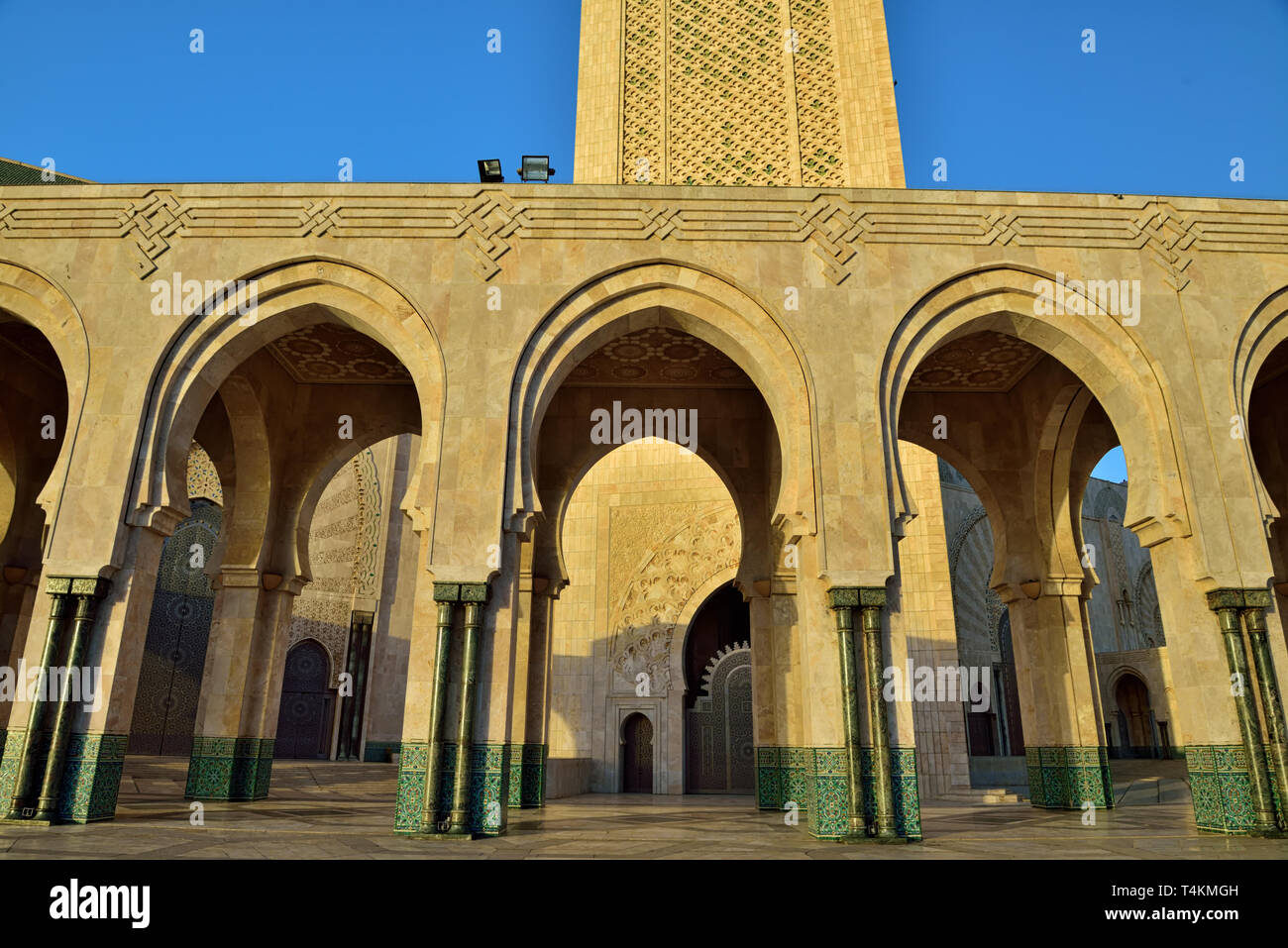 The style of the Hassan II Mosque displays strong Moorish influences, bringing to mind the Alhambra and Mezquita in Spain. Horseshoe arches prevail bo Stock Photo