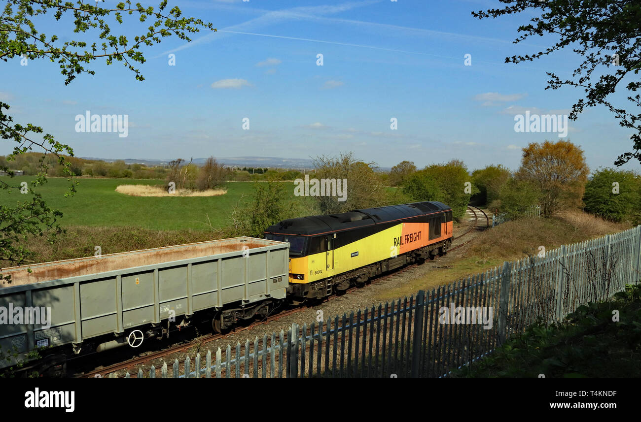 A GBRF, diesel locomotive propels its train of empty stone wagons off the branch line to the Hanson aggregate depot at Ashton in Makerfield. Cw 6688. Stock Photo