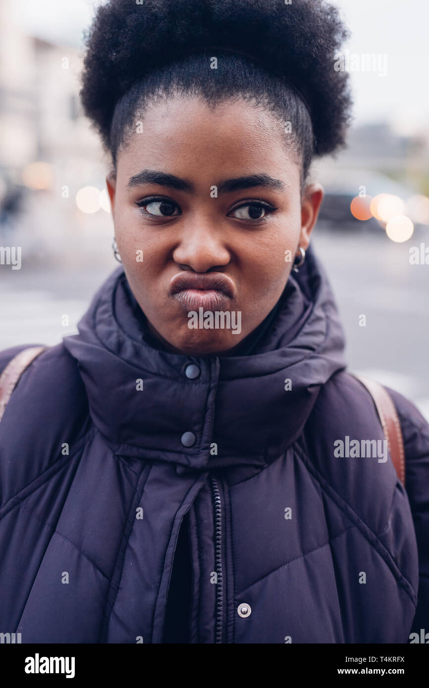 black and curly girl pulling faces - expressivity, funny, cheerful Stock Photo