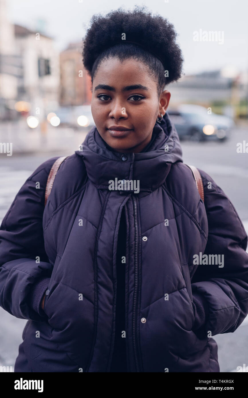 young and curly black girl in the city  looking at the camera - youth,expressivity,indipendence Stock Photo