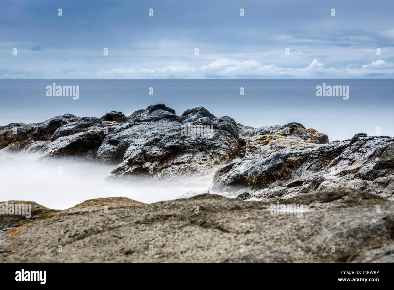 Seascape coastline of west Tenerife at dawn made using long exposure photography with nuetral density filters to create silky water and movement in th Stock Photo