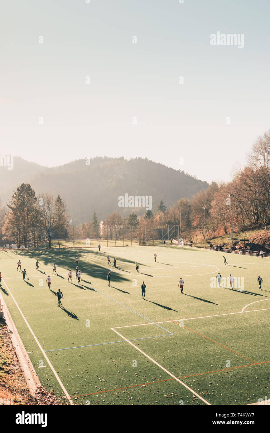 Football / soccer team playing a local match on a green field on a sunday afternoon. Stock Photo