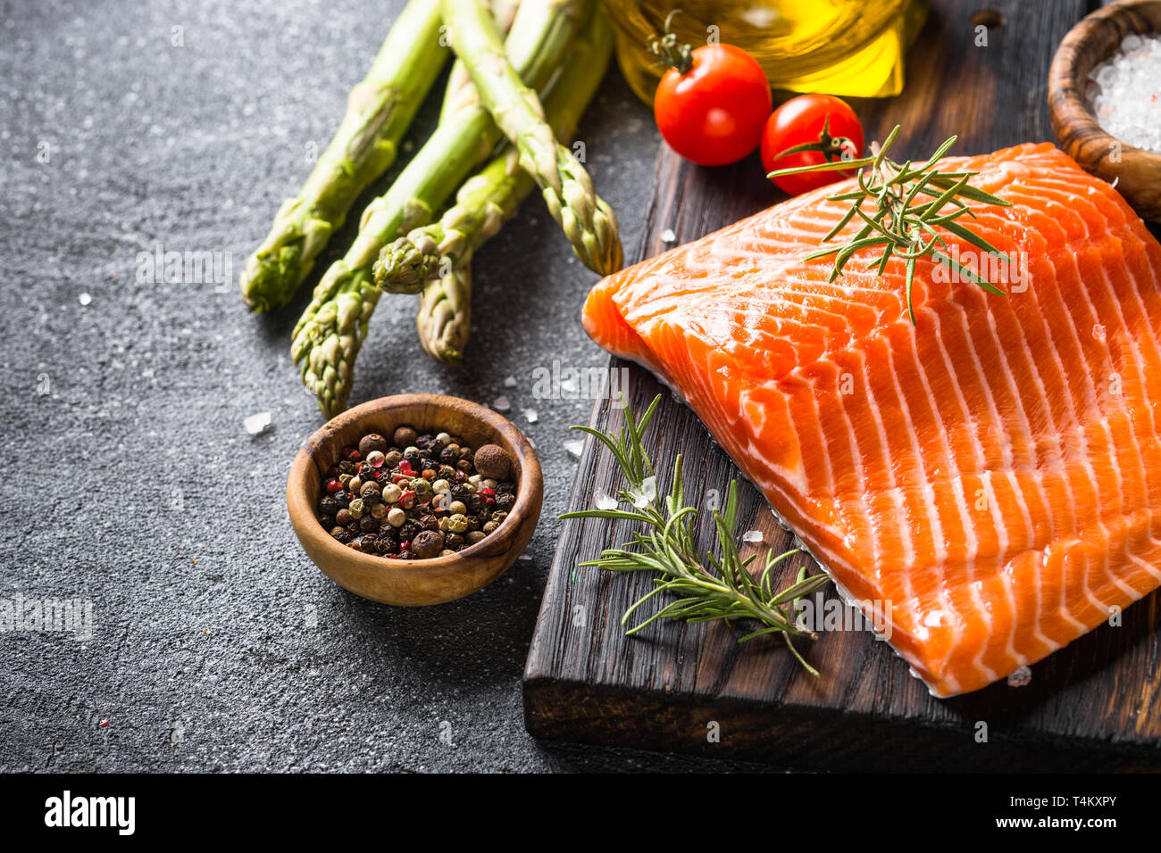 Salmon fillet on black background Stock Photo - Alamy