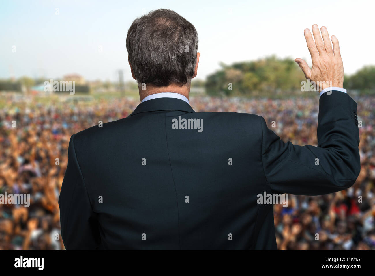 Politician talking and making an oath with his arm raised Stock Photo
