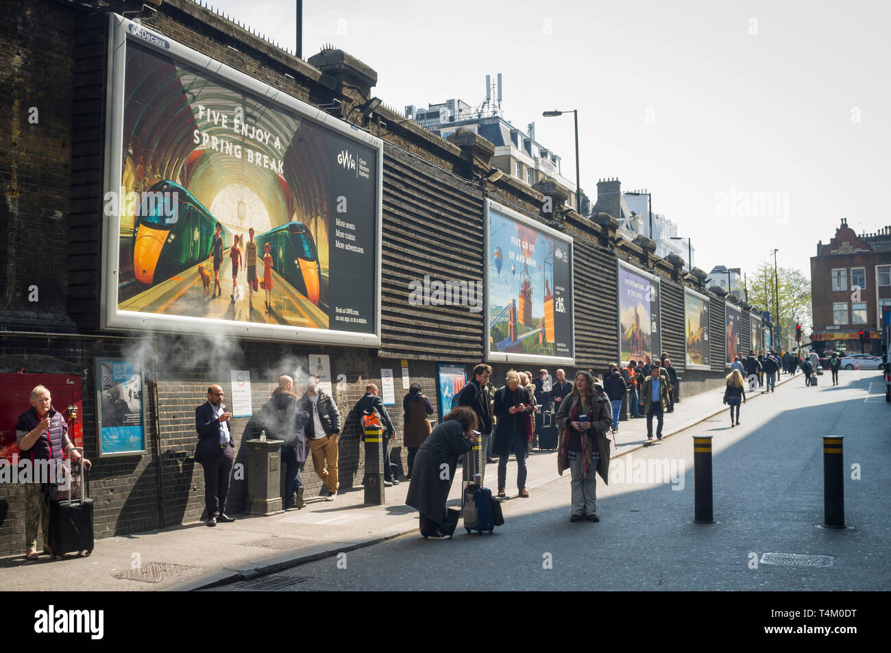 Smokers using the exterior smoking area outside Paddington Station