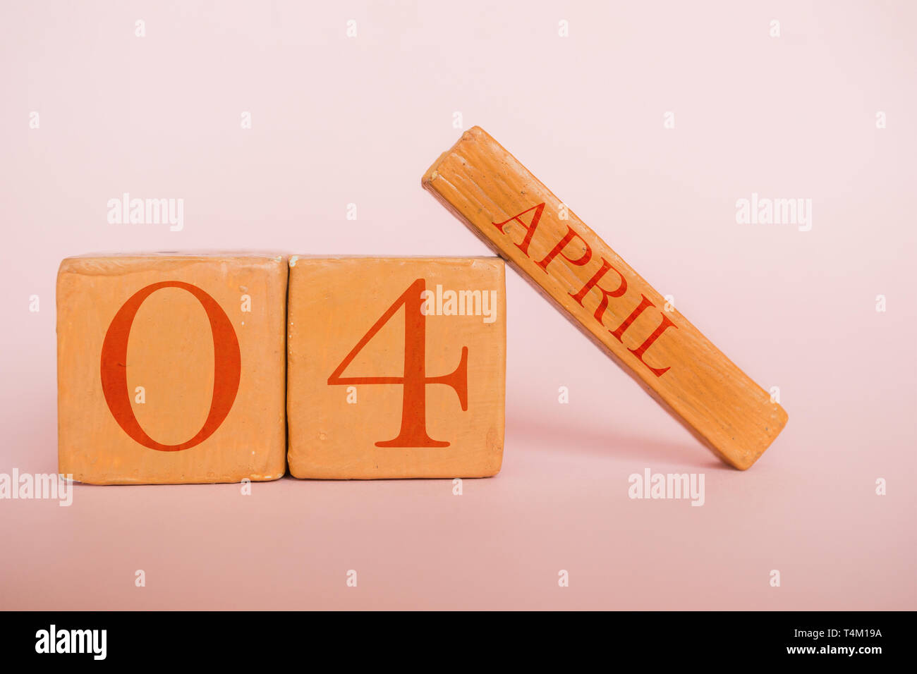 april 4th. Day 4 of month, handmade wood cube calendar on modern color ...