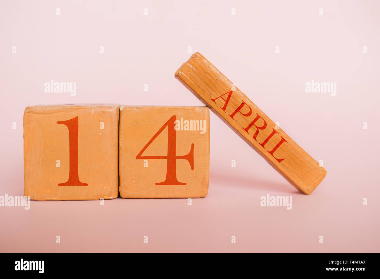 april 14th. Day 14 of month, handmade wood cube calendar on modern