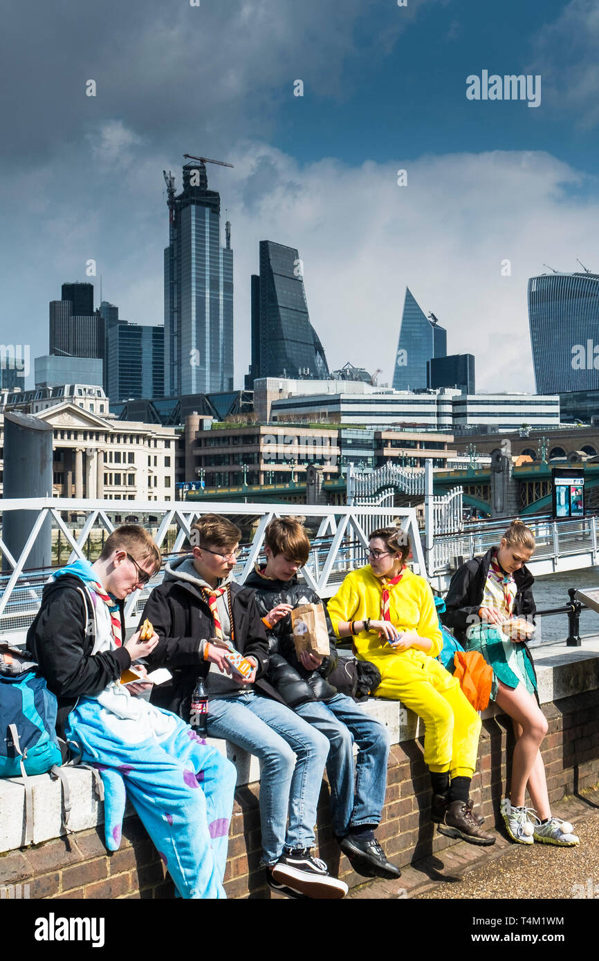 A group of Scouts eating food on the South Bank in London Stock Photo ...