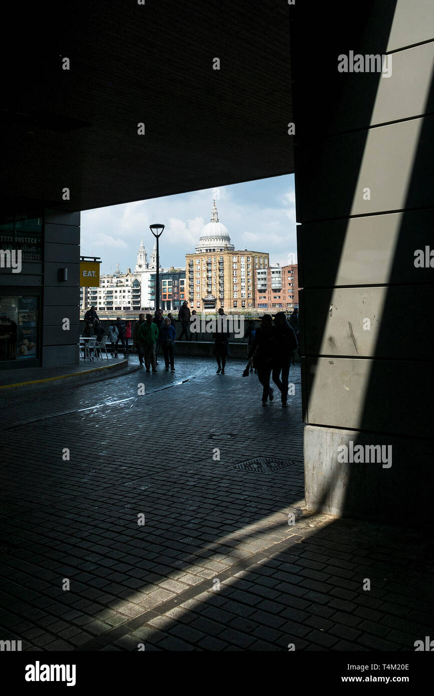 The dome of St Paul’s Cathedral seen from a dark underpass on the Southbank in London. Stock Photo