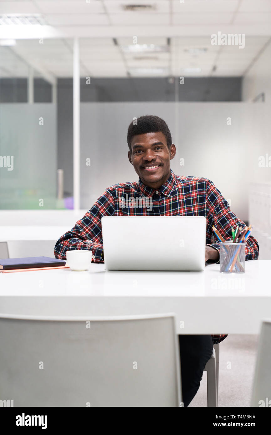 Happy African student at laptop computer in a continuing education course Stock Photo