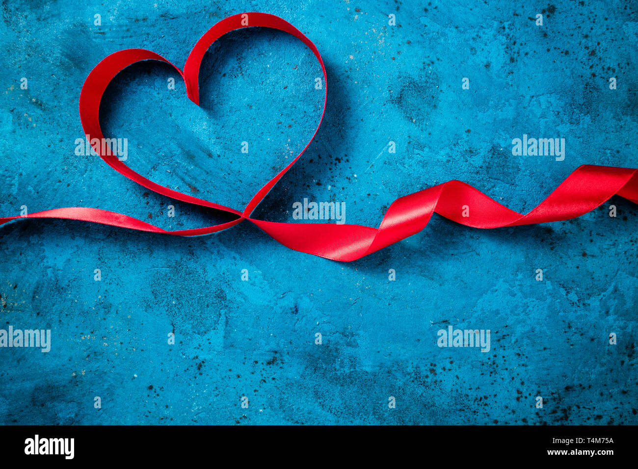 Valentines Day background with red heart. Heart shape from ribbons ...