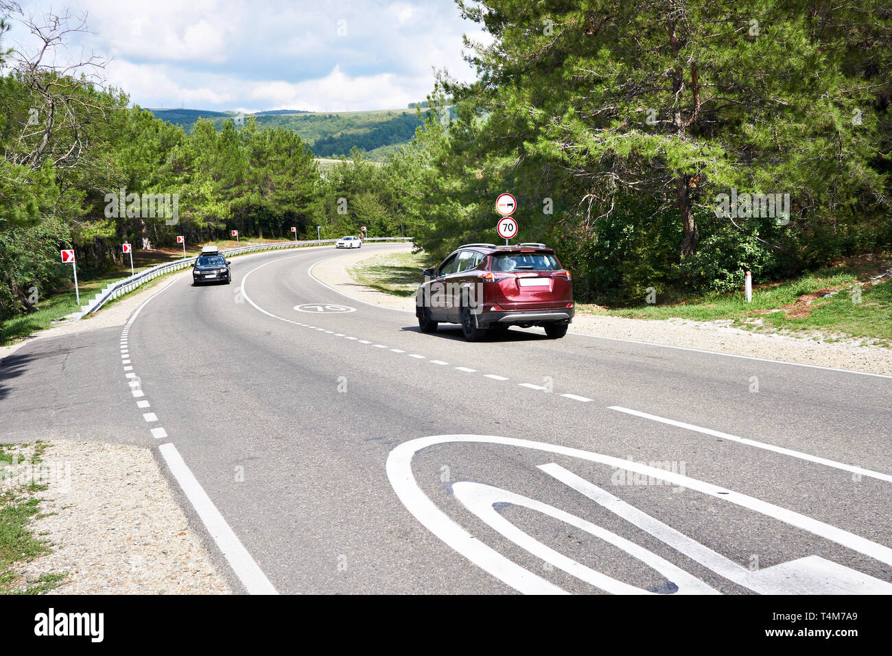 Cars on the sunny mountain road Stock Photo - Alamy