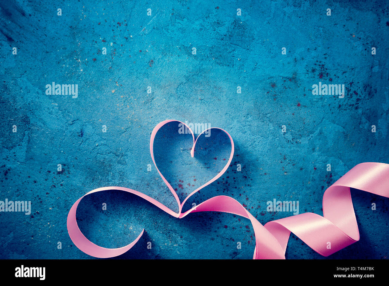 Valentines Day background with pink heart. Heart shape from ribbons ...