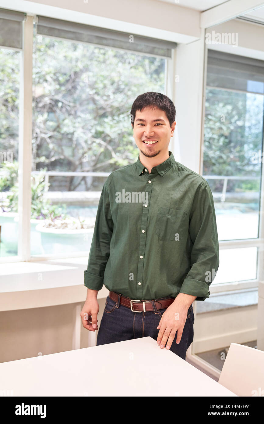 Young man as self-confident trainee or intern in the office or seminar Stock Photo