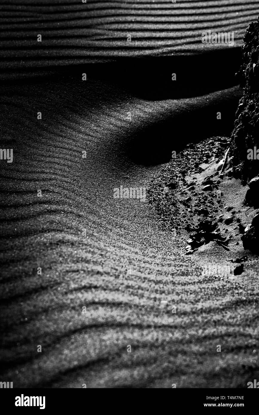 beautiful dark sandy curves covered in shadow taken in Bolonia, Spain in black and white Stock Photo