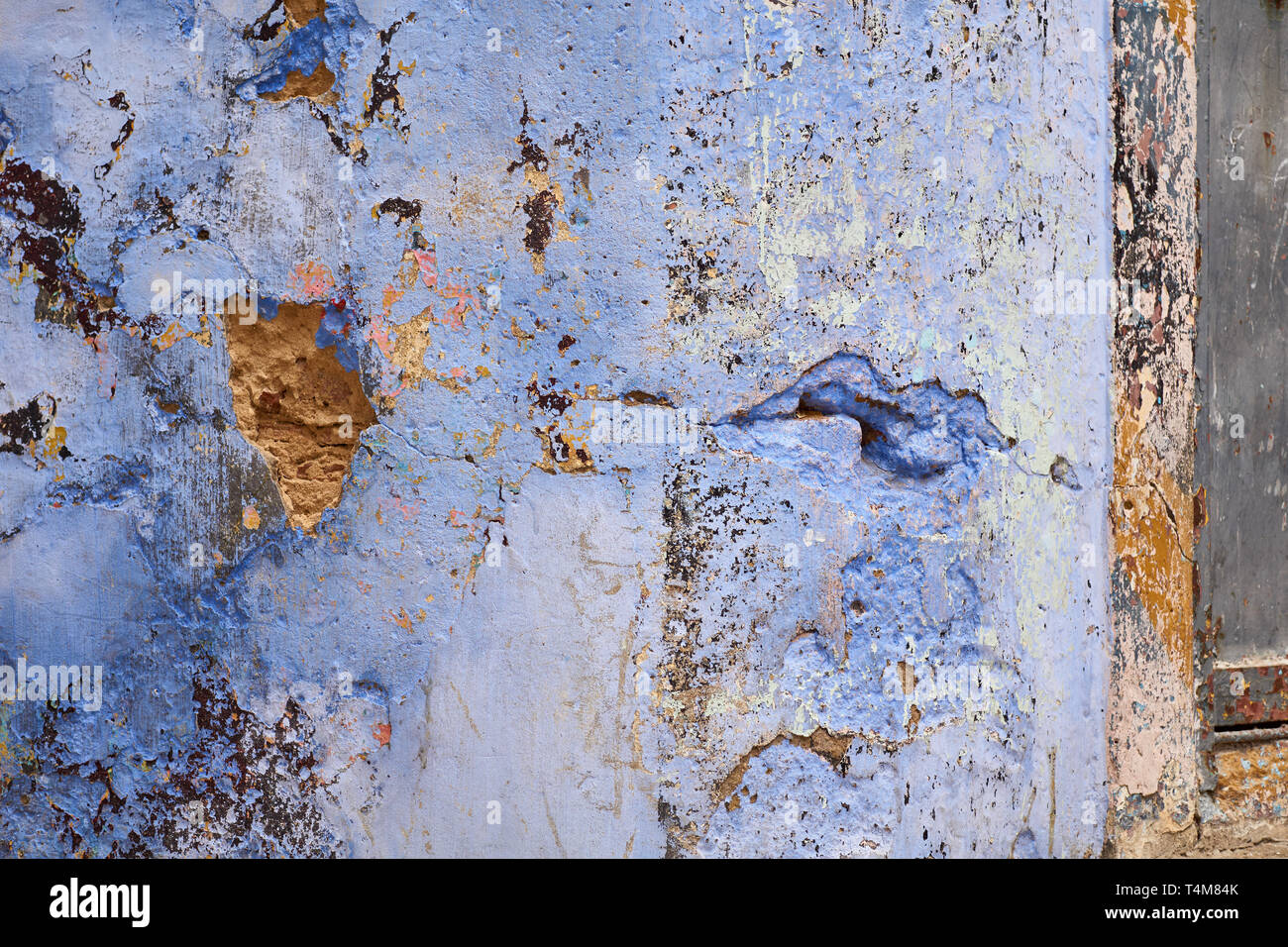 Closeup of a crumbling blue house wall full of texture in the medina (kasbah area) of Tangier (Tanger), Morocco Stock Photo