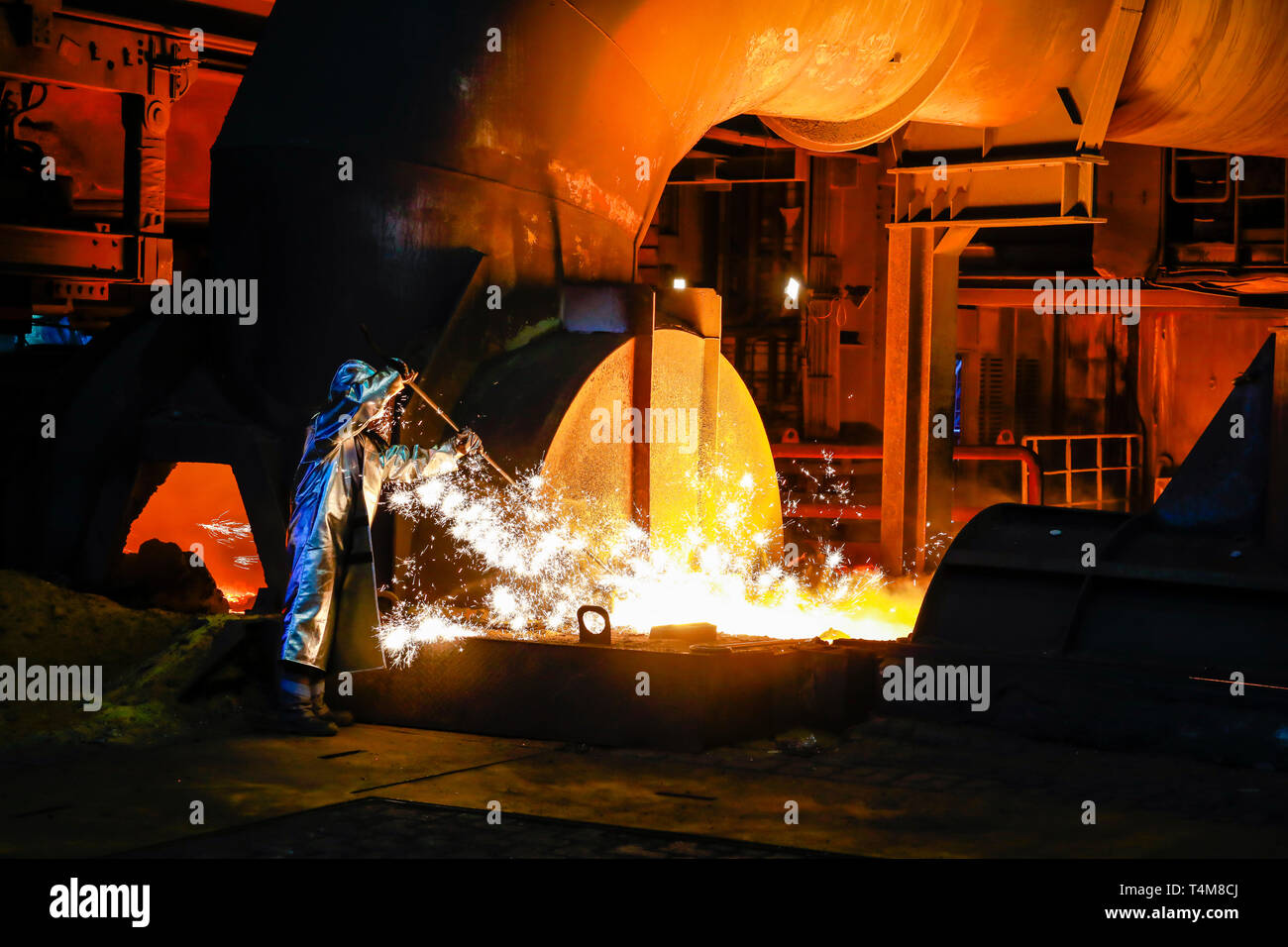 Duisburg, Ruhr area, North Rhine-Westphalia, Germany - ThyssenKrupp Steel, a steel worker in a protective suit takes a 1500 degree hot pig iron sample Stock Photo