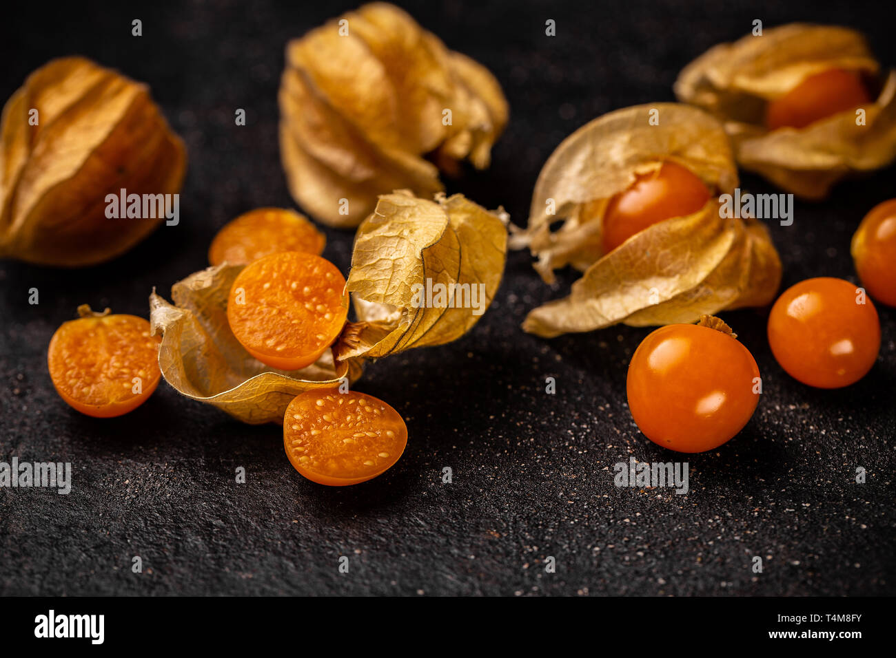 Close up of Cape gooseberry or Physalis on black surface Stock Photo