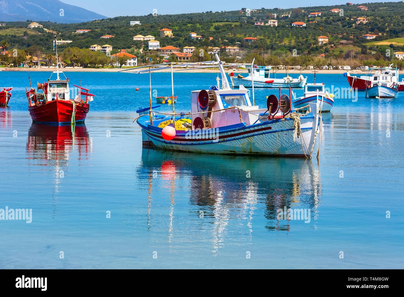 Reflection in sea water of fishing boats in greek village Methoni in  Messinia, Peloponnese, Greece Stock Photo - Alamy