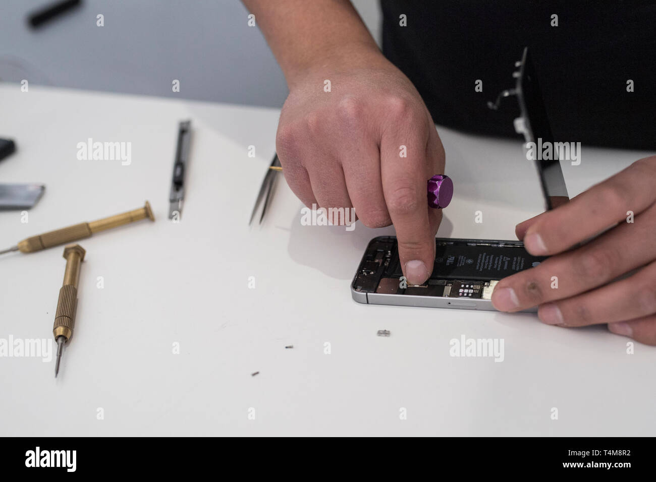 Changing a battery on a iphone Stock Photo