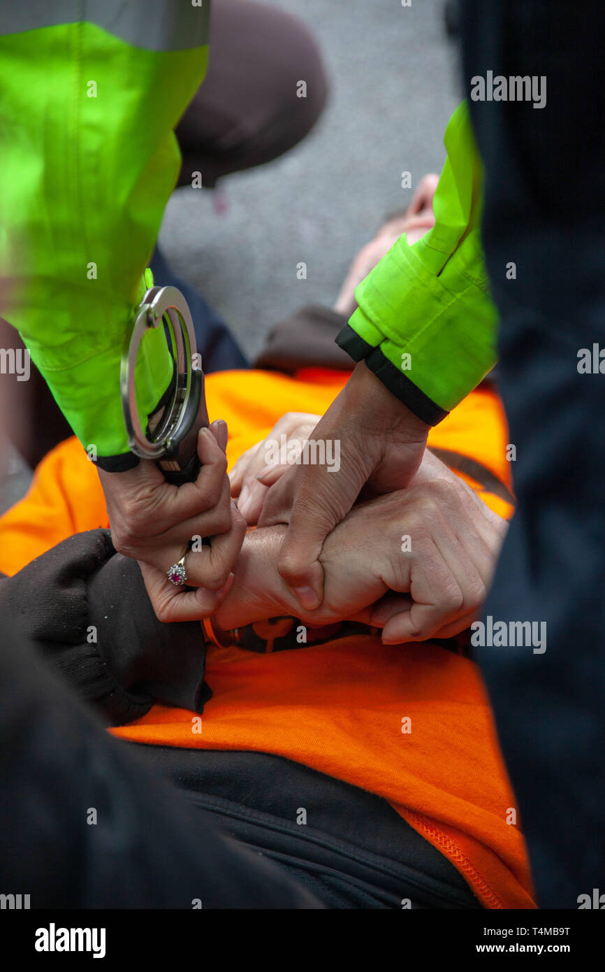 16th April 2019: Extinction Rebellion: Protester getting handcuffed and arrested on Waterloo Bridge, London, UK Stock Photo
