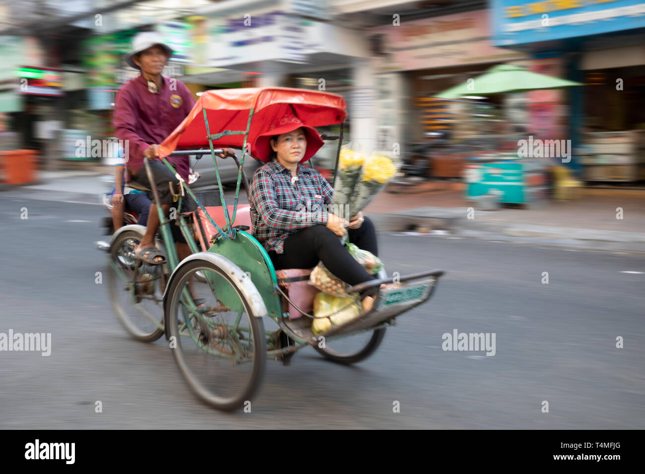 Panned image of moving cyclo, Phnom Penh, Cambodia, Southeast Asia, Asia Stock Photo