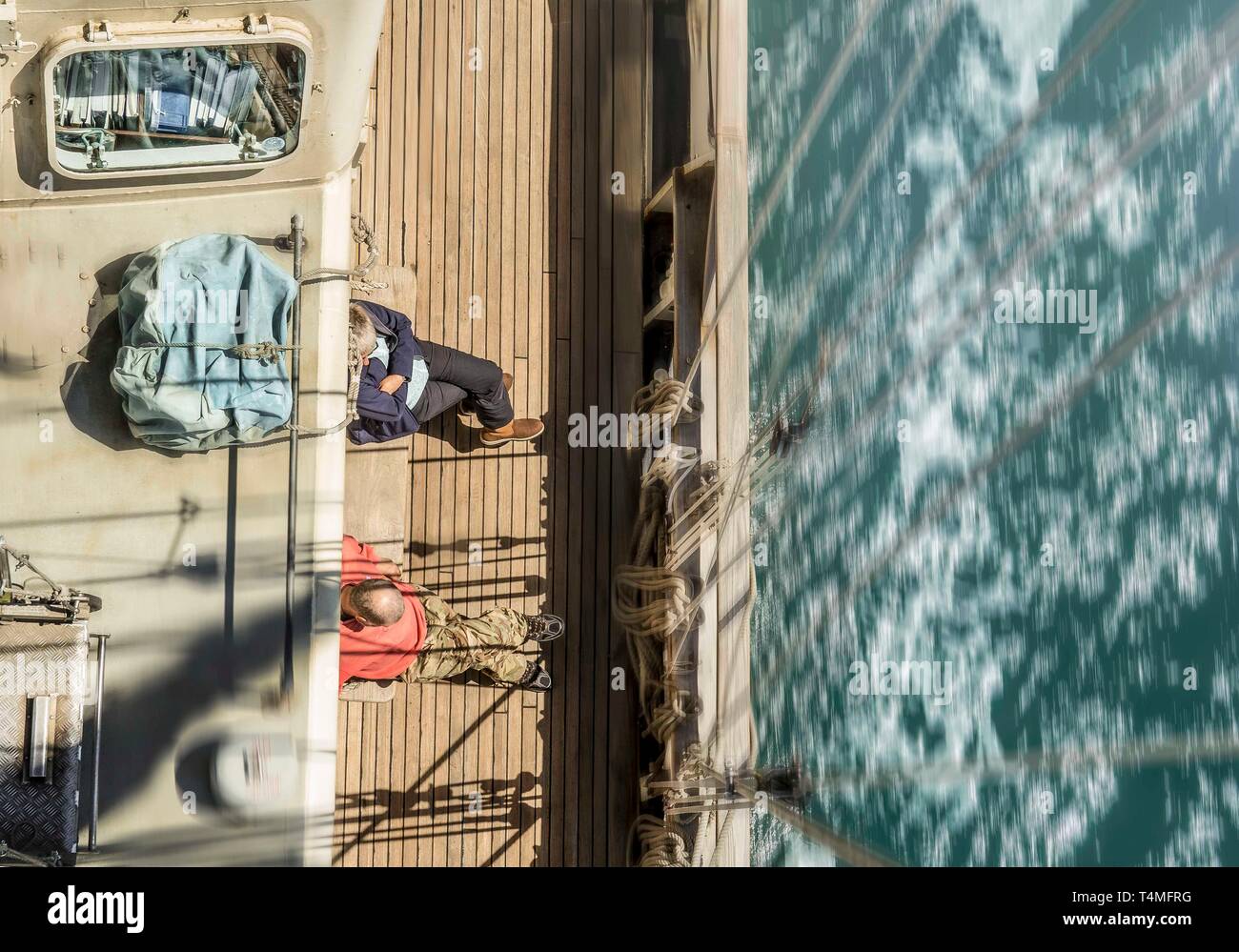 A birds eye view with motion from the mast of the Lord Nelson under sail in the UK. Stock Photo