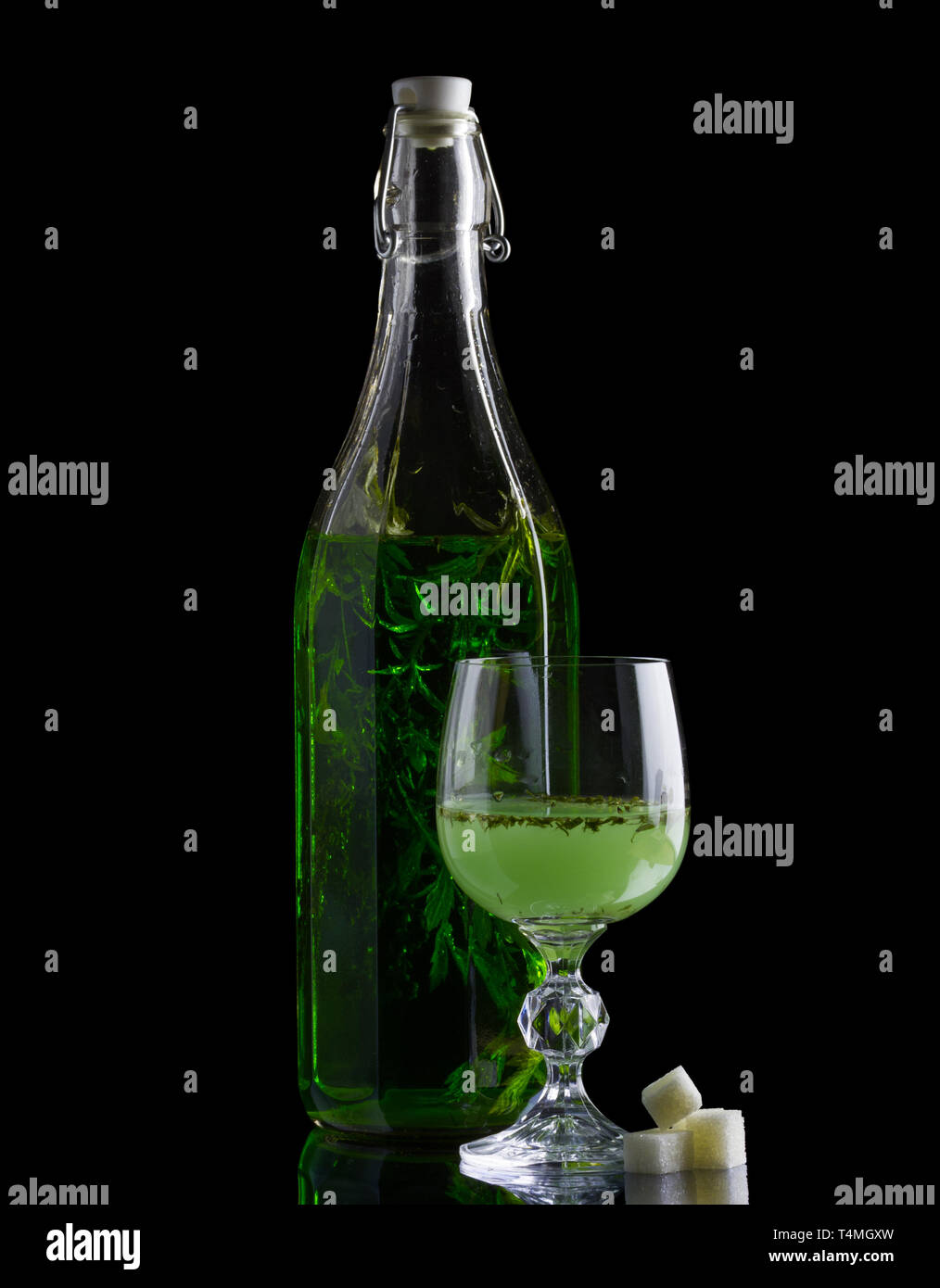 Absinthe with sugar bottle and glass isolated on black Stock Photo