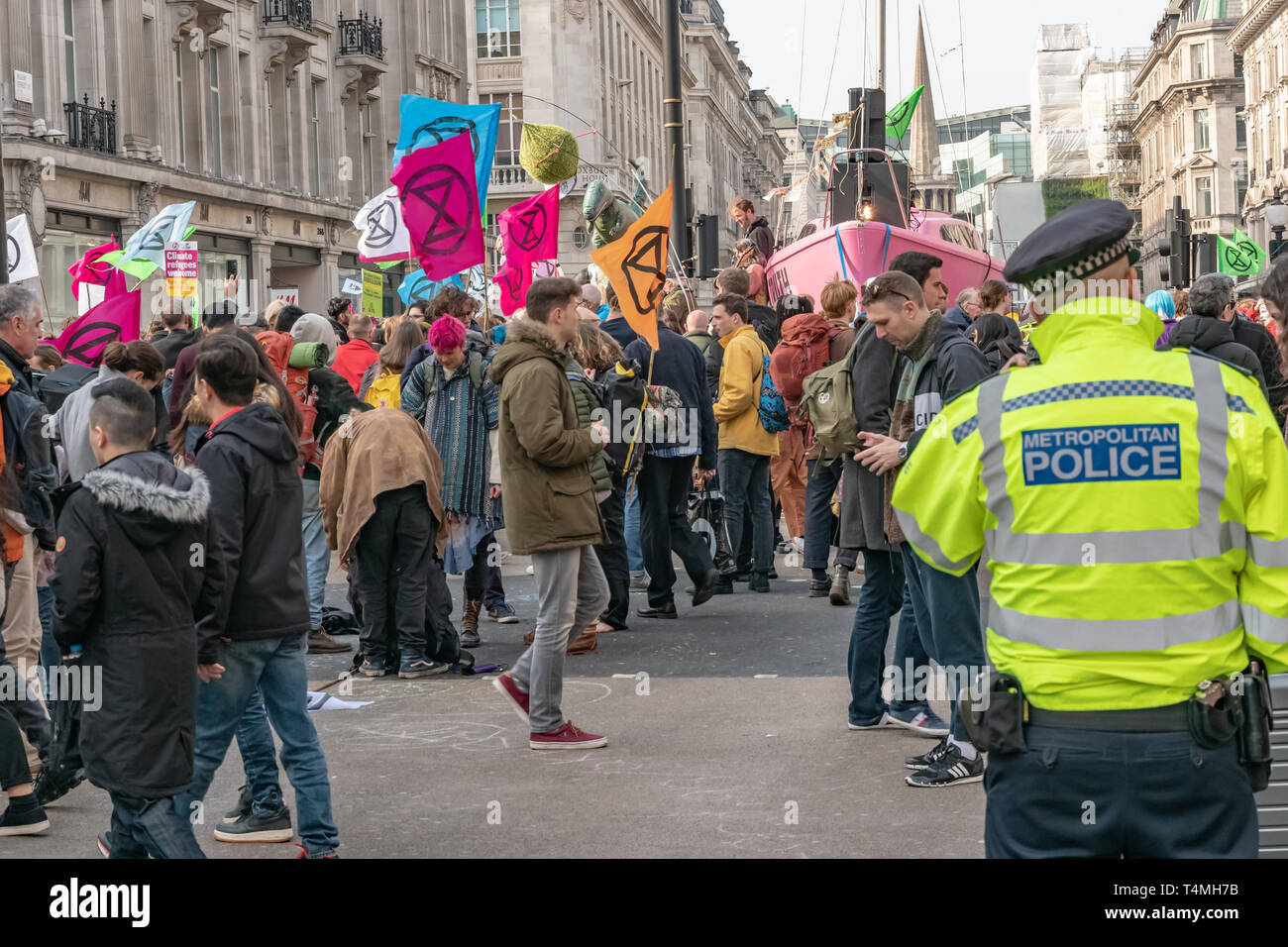 London, UK - April 15, 2019: Metropolitan Police officers patrols at Oxford street. Extinction Rebellion campaigners barricade at Oxford Circus, Stock Photo