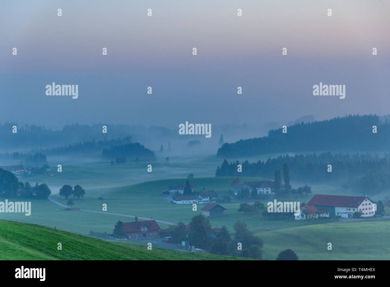 Morning dawn with fog in the Alpine foothills Stock Photo