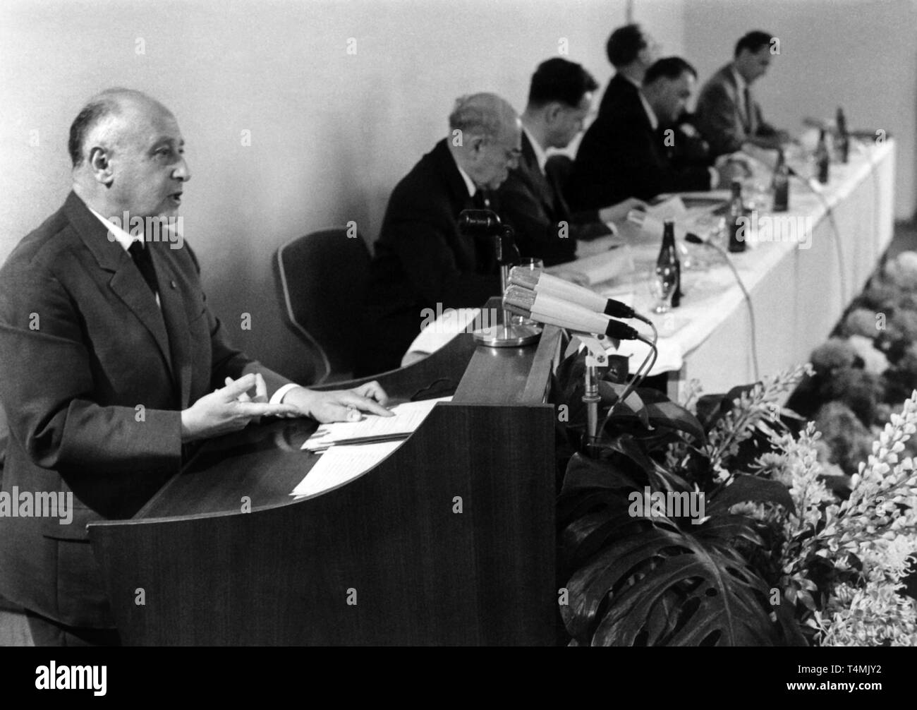 Professor Albert Norden (FRONT), member of the politburo of the Central Committee of the GDR and of the executive committee of the National Council, pictured during his speech during a press conference of the National Front of the German Democratic Republic in East Berlin on 29 June 1966. In the background, leading party deputies of the democratic block of the GDR are pictured:   Paul Scholz (L-R), Deputy of the Chairman of the Democratic Farmers' Party of Germany and Deputy Chairman of the Council of Ministers in the GDR,   Dr. Manfred Gerlach, Secretary General of the Liberal Democratic Part Stock Photo