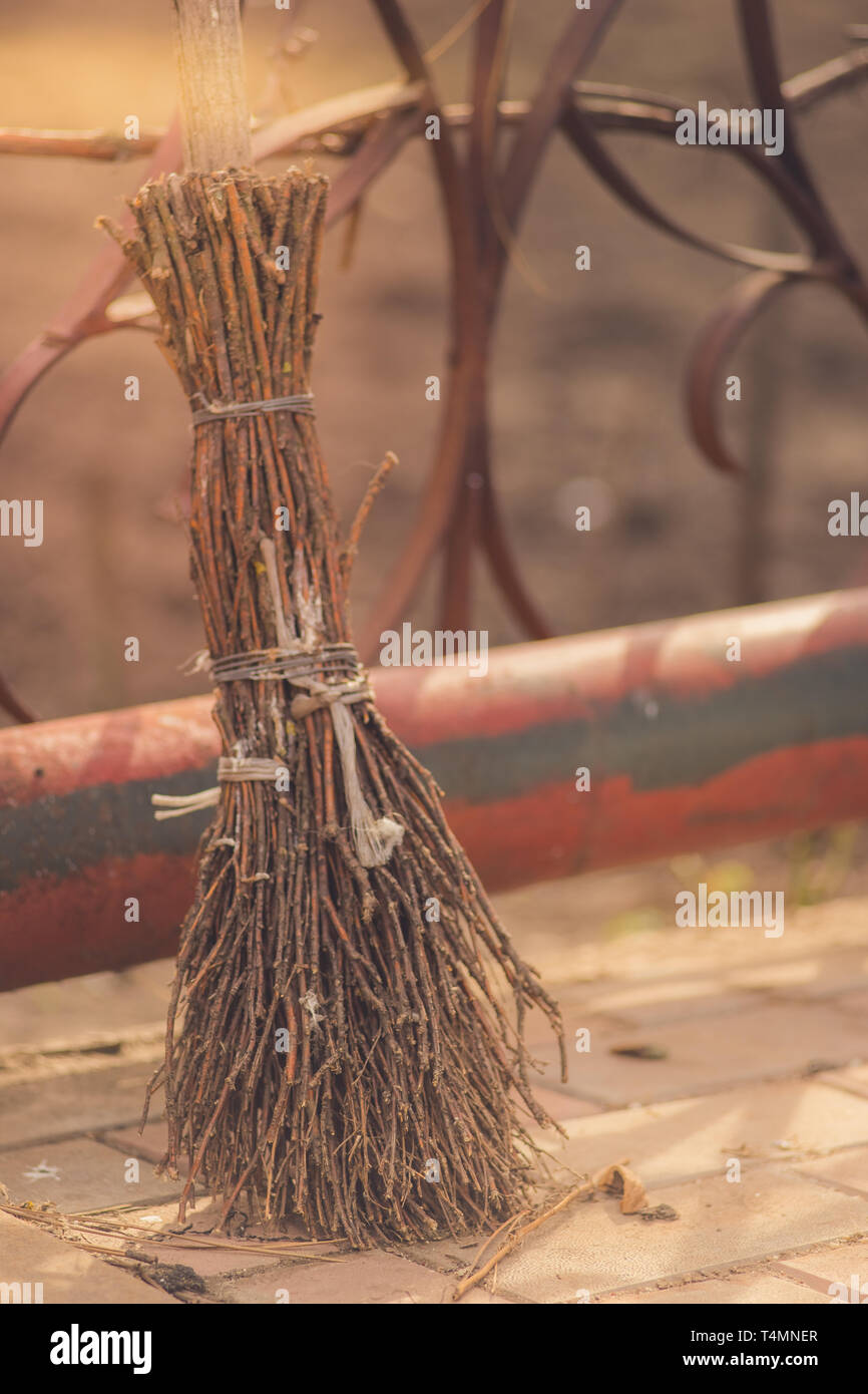 Old homemade broom made from the branches stands in the courtyard with sunlight Stock Photo Alamy