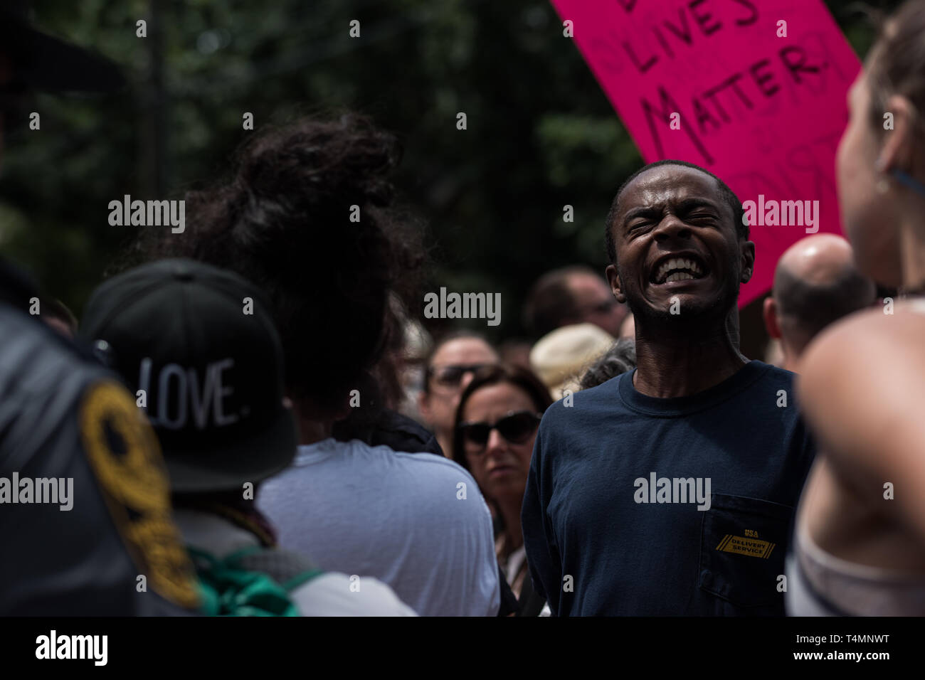 Emotional Black Man at KKK Rally Stock Photo
