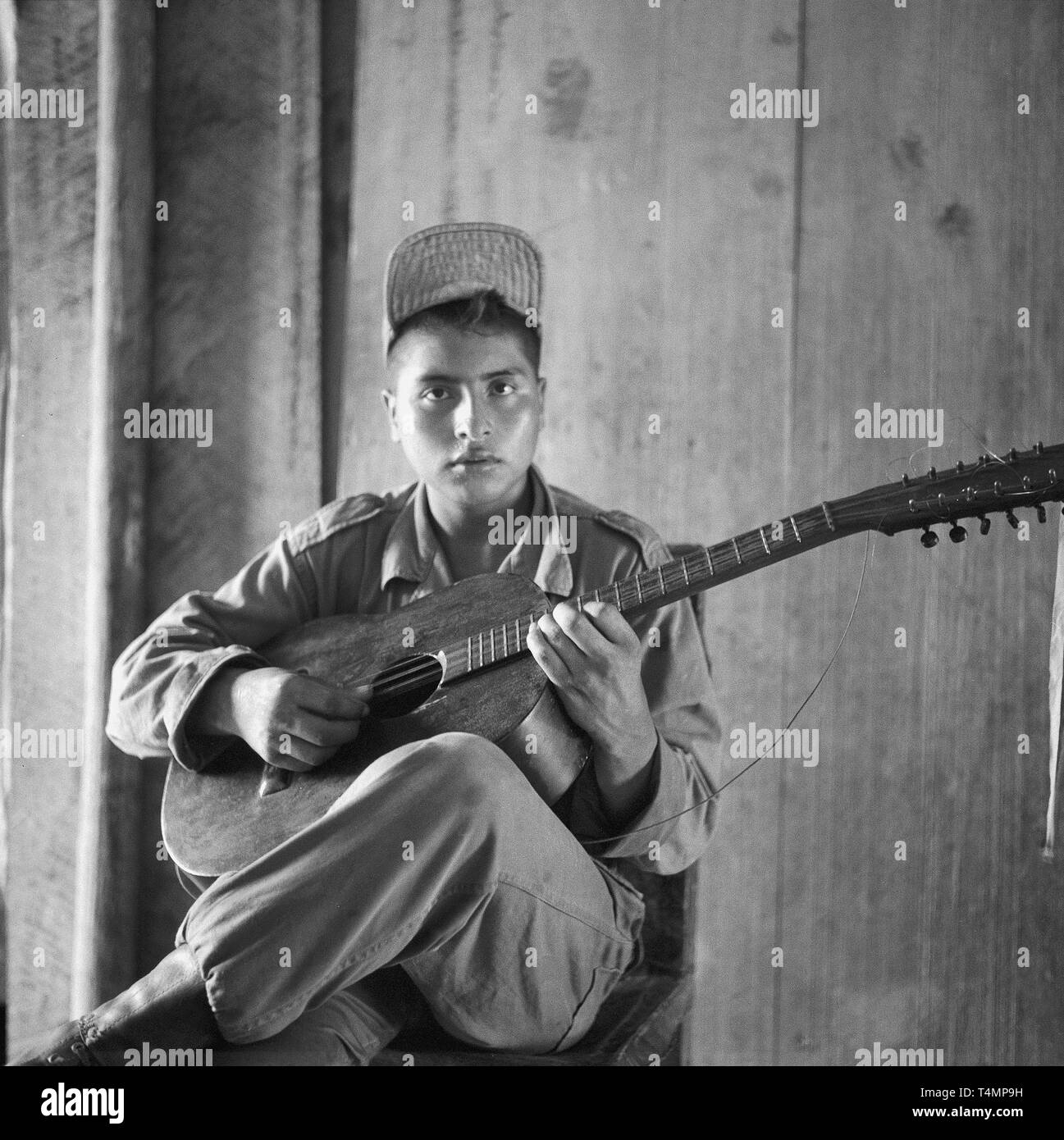 Guitar playing soldier, Rio Magdalena at Barrancabermeja, Columbia, 1958. | usage worldwide Stock Photo