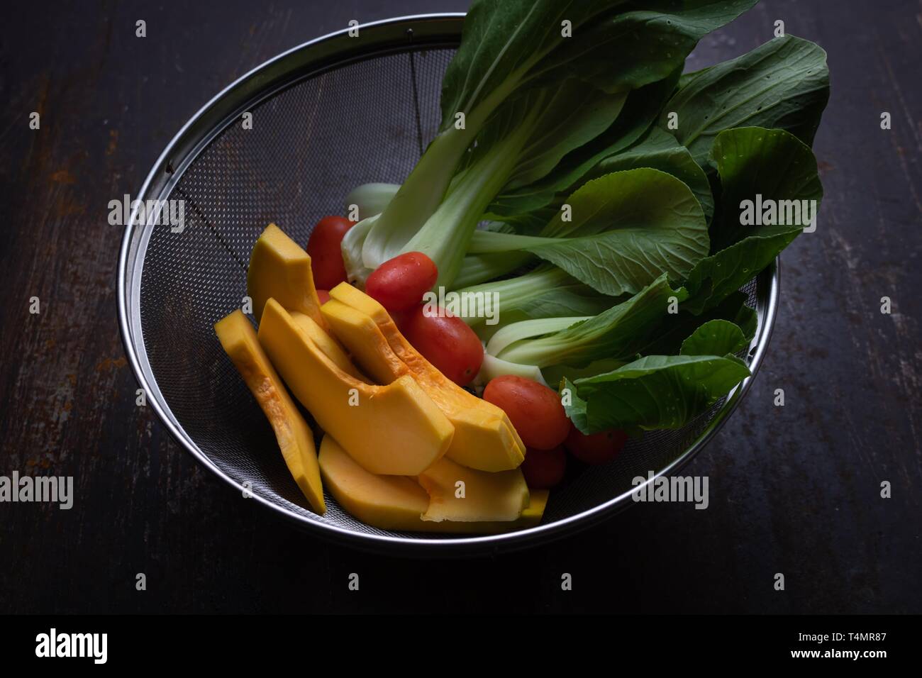 Vegetables in wire basket Stock Photo Alamy