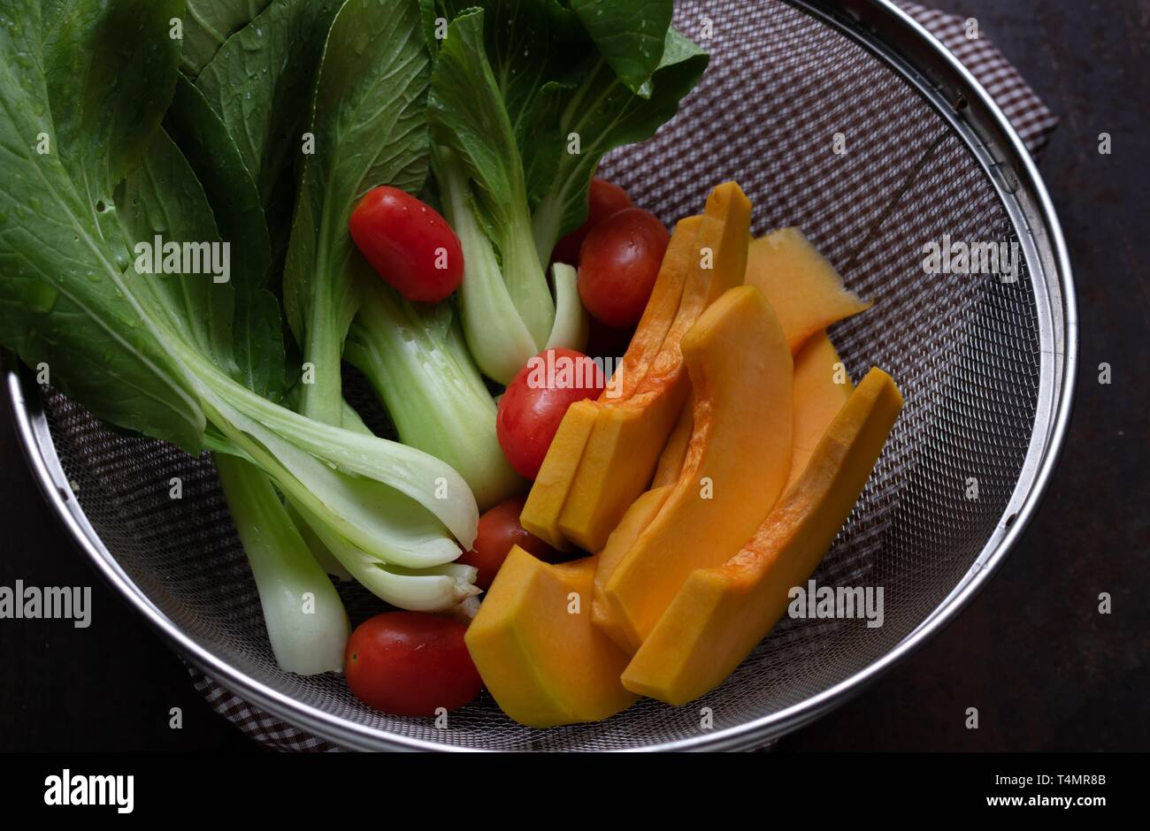 Vegetables in wire basket Stock Photo Alamy