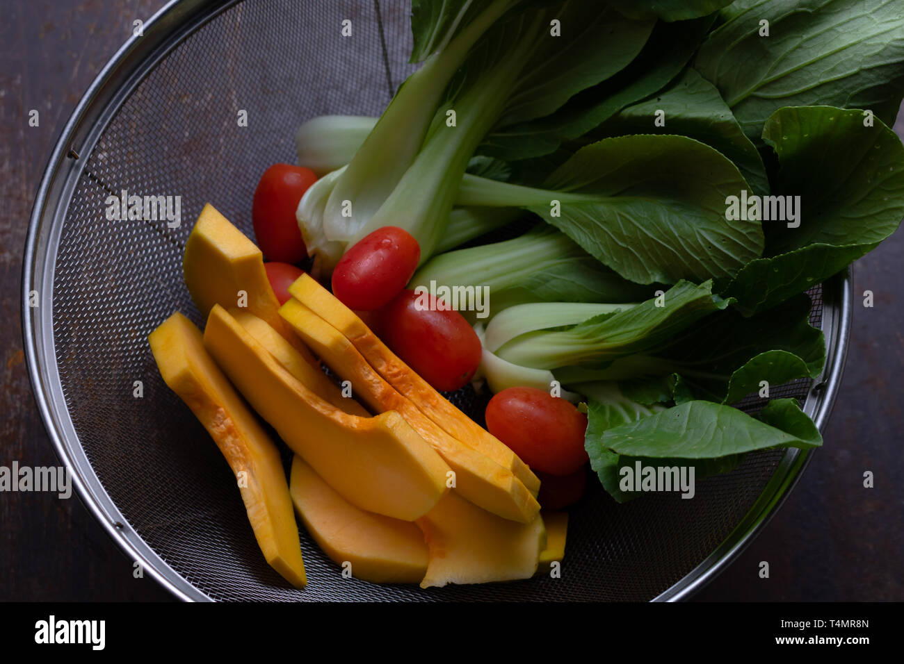 Vegetables in wire basket Stock Photo Alamy
