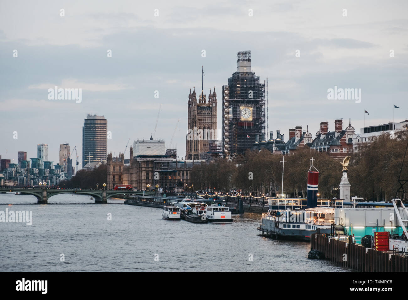 London, UK - April 13, 2019: View of London skyline and Big Ben in scaffolding from Millennium Bridge. London is one of the most visited cities in the Stock Photo