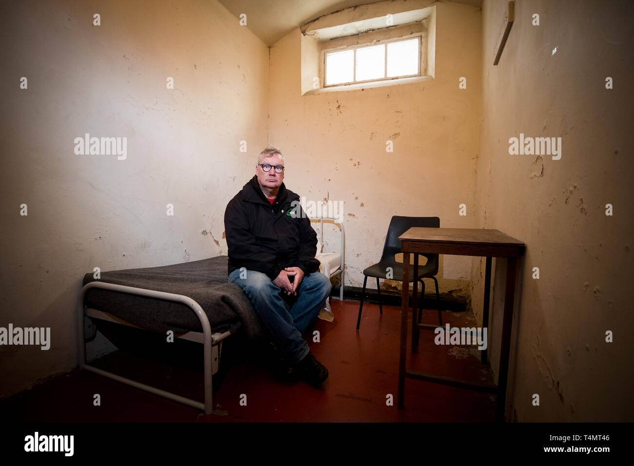 Cioste tour guide Peadar Whelan inside a C wing prison cell of Crumlin Road Gaol in Belfast which is part of a new Troubles themed tour. Stock Photo
