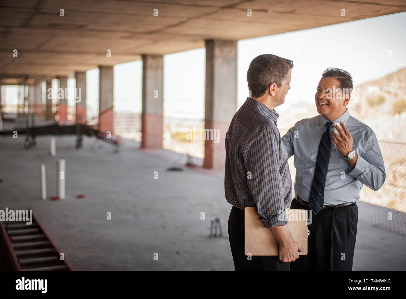 Two executives talking on construction site. Stock Photo