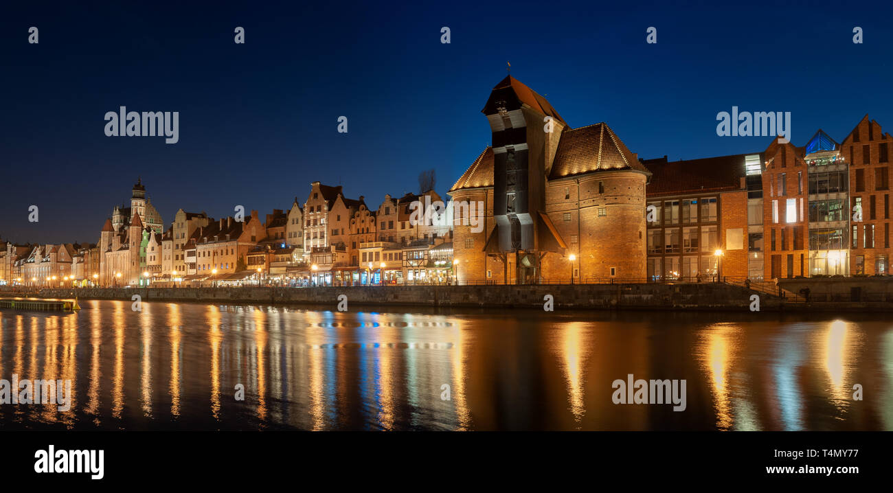 Old town in Gdansk, Poland at night. Riverside with the famous Crane and city reflections in the Motlava river. Stock Photo