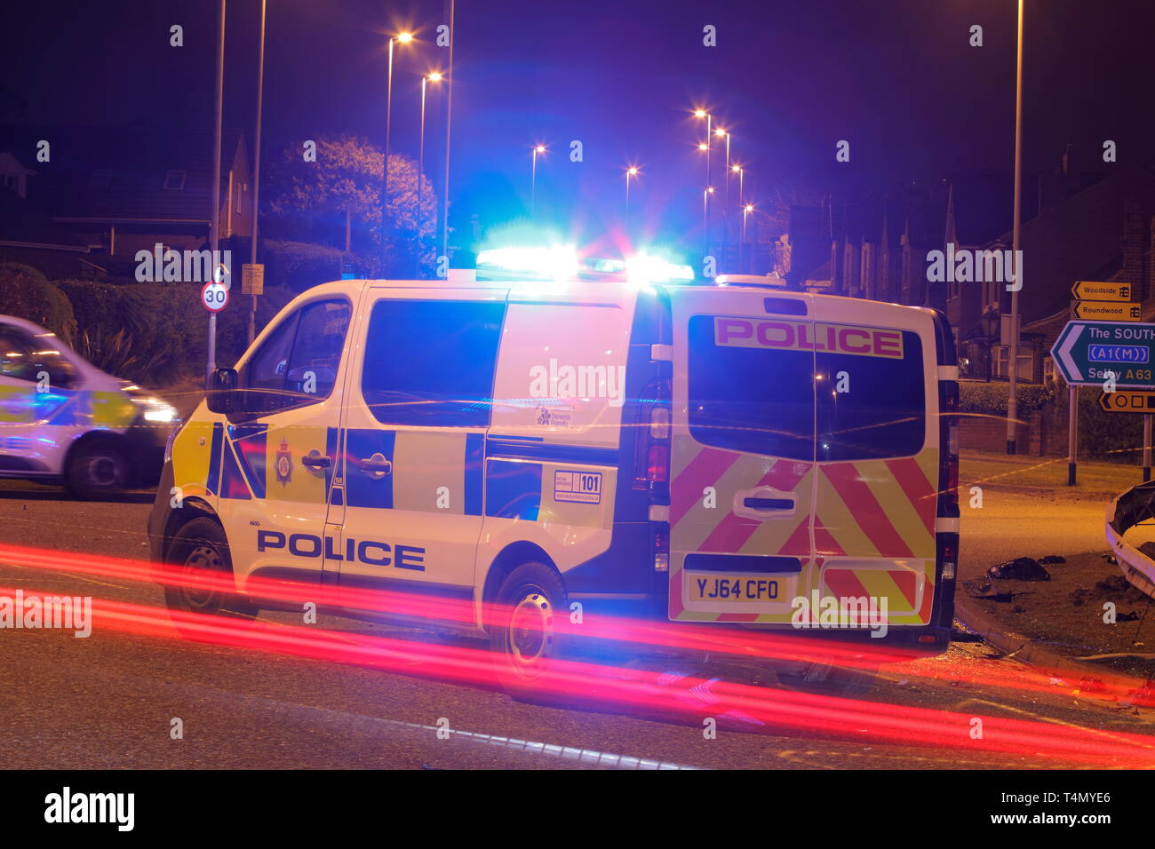 A police van used as a road block at the scene of a road traffic collision outside the Miller & Carter in Garforth, Leeds. Stock Photo