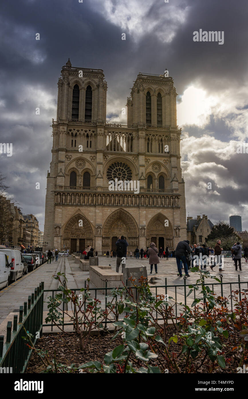 Tourists visiting the Cathedral Notre Dame de Paris - most famous Roman  Catholic cathedral (1163 - 1345) on the eastern half of the Cite Island  Stock Photo - Alamy